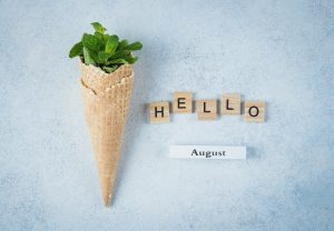 Ice cream waffle cone with mint leaves. Summer card concept. Hello August Top view, flat lay