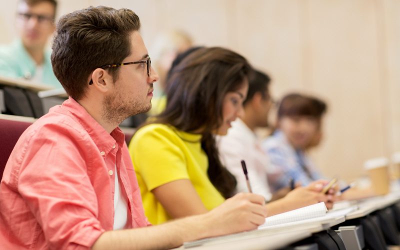 group of students with notebooks in lecture hall
